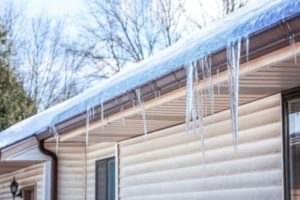 Icicles caused by ice dams hanging from gutters.