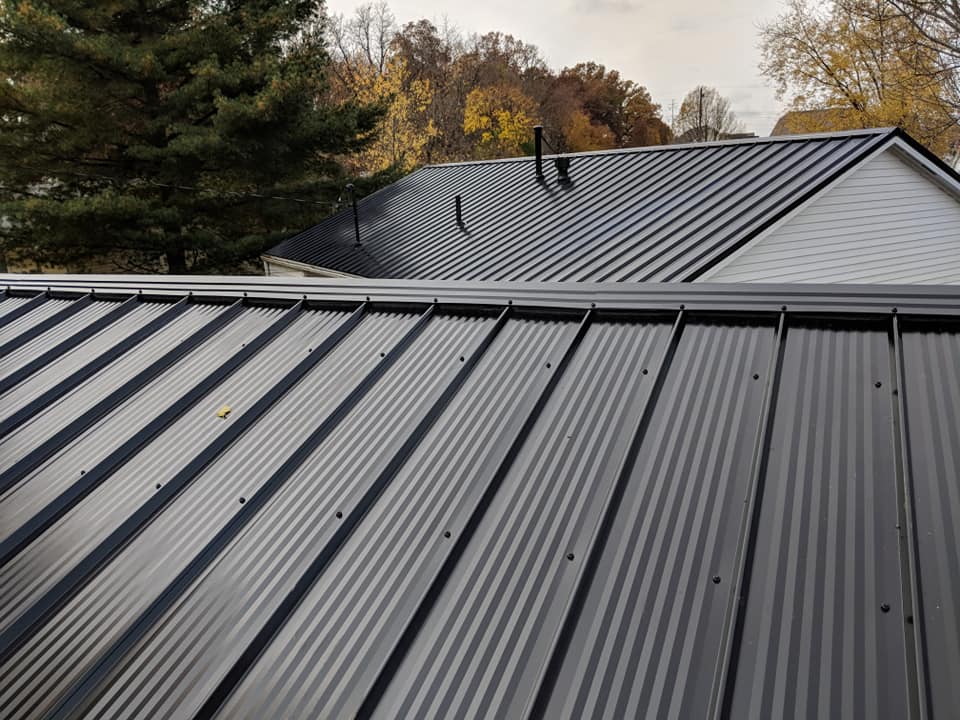 A newly installed black standing seam metal roof.