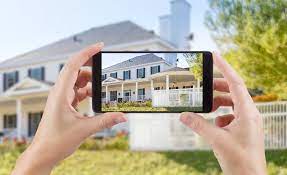 Homeowner taking photos of a home on their iPhone.