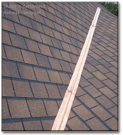 Open metal roof valley on an asphalt roof. 