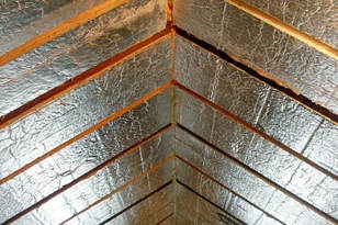 Close up of roof insulation in an attic.